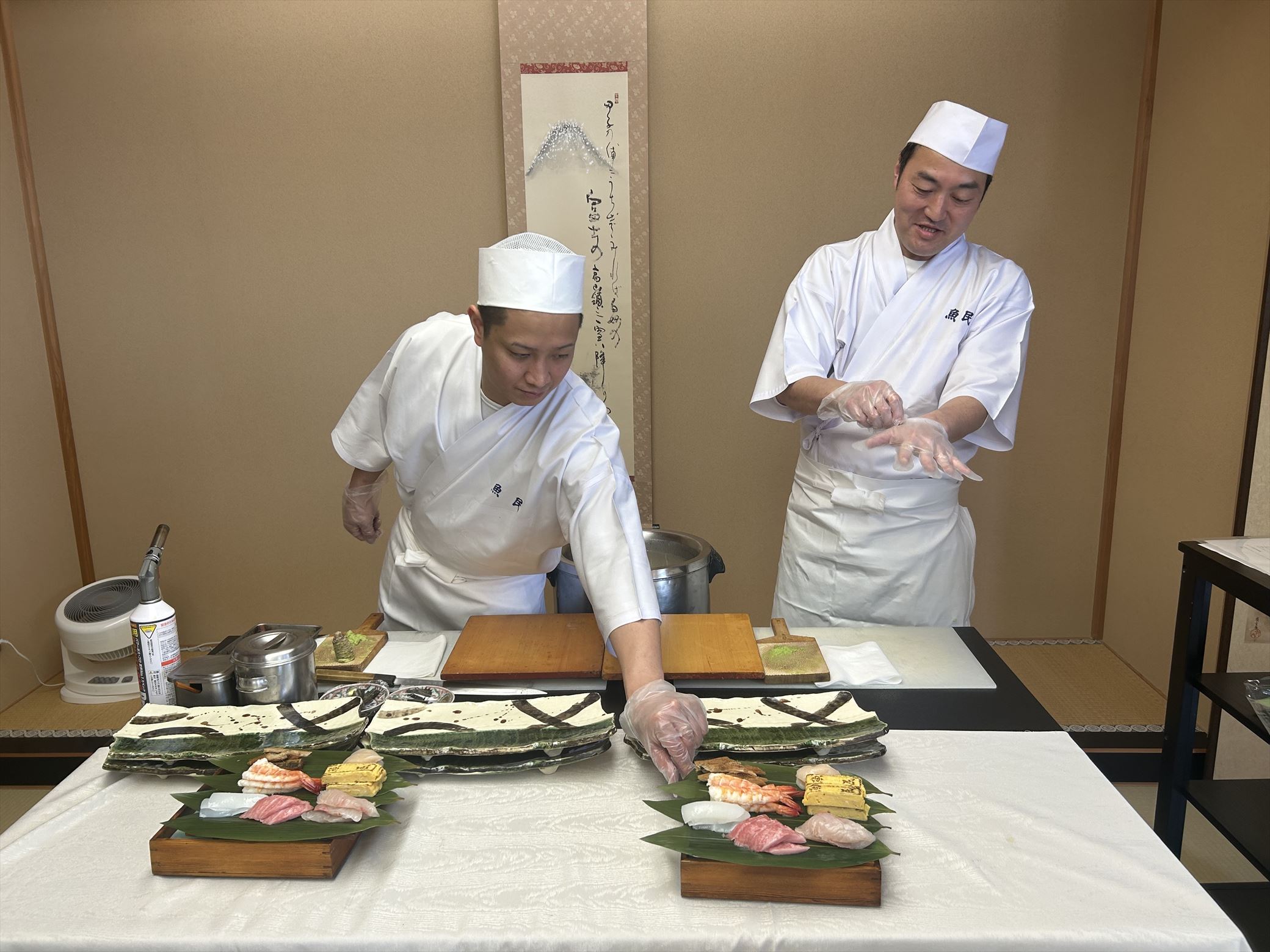 Skilled sushi chefs quickly and gracefully prepareing sushi with expert precision.