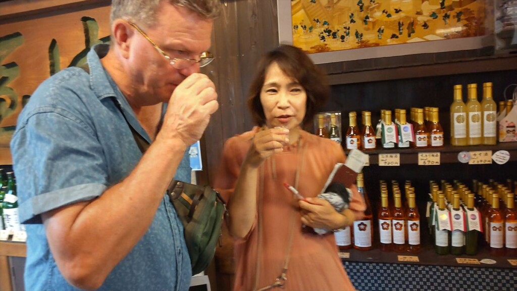 Guest sampling sake during a tasting session at Takasago Brewery.