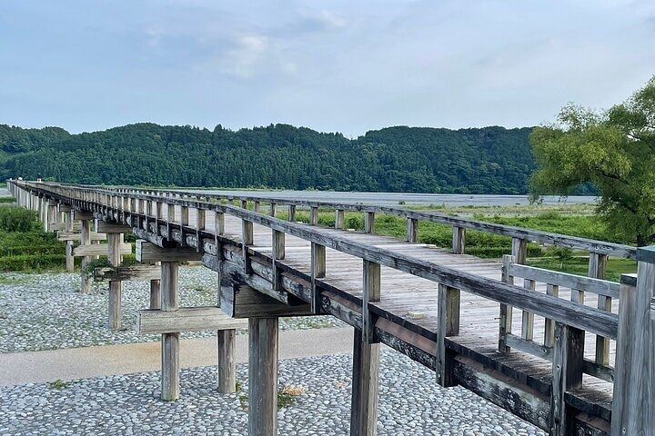 Angled view of Horai Bridge’s wooden silhouette over the Oi River in Shimada, originally constructed in 1879 during the Meiji era.

