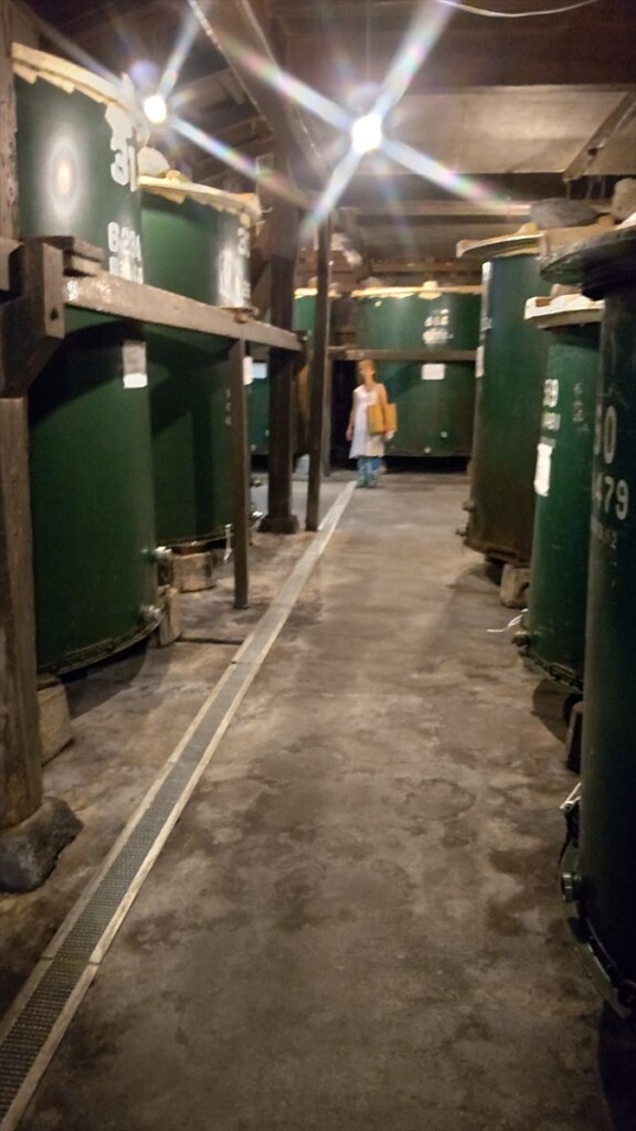 Rows of large stainless steel tanks used for sake fermentation inside Takasago Brewery in Fujinomiya.